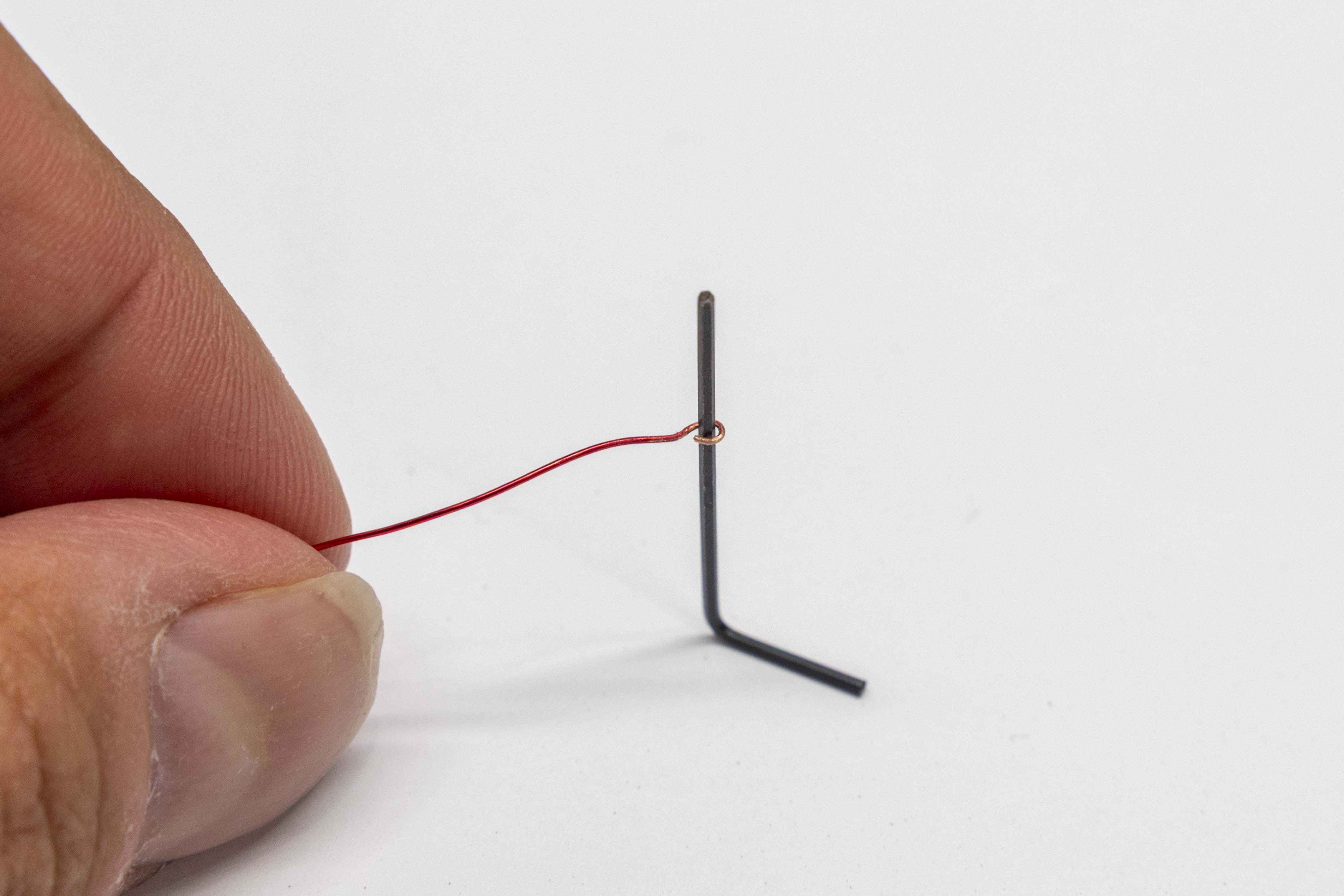 Magnet wire being looped around 0.9mm hex key mandrel