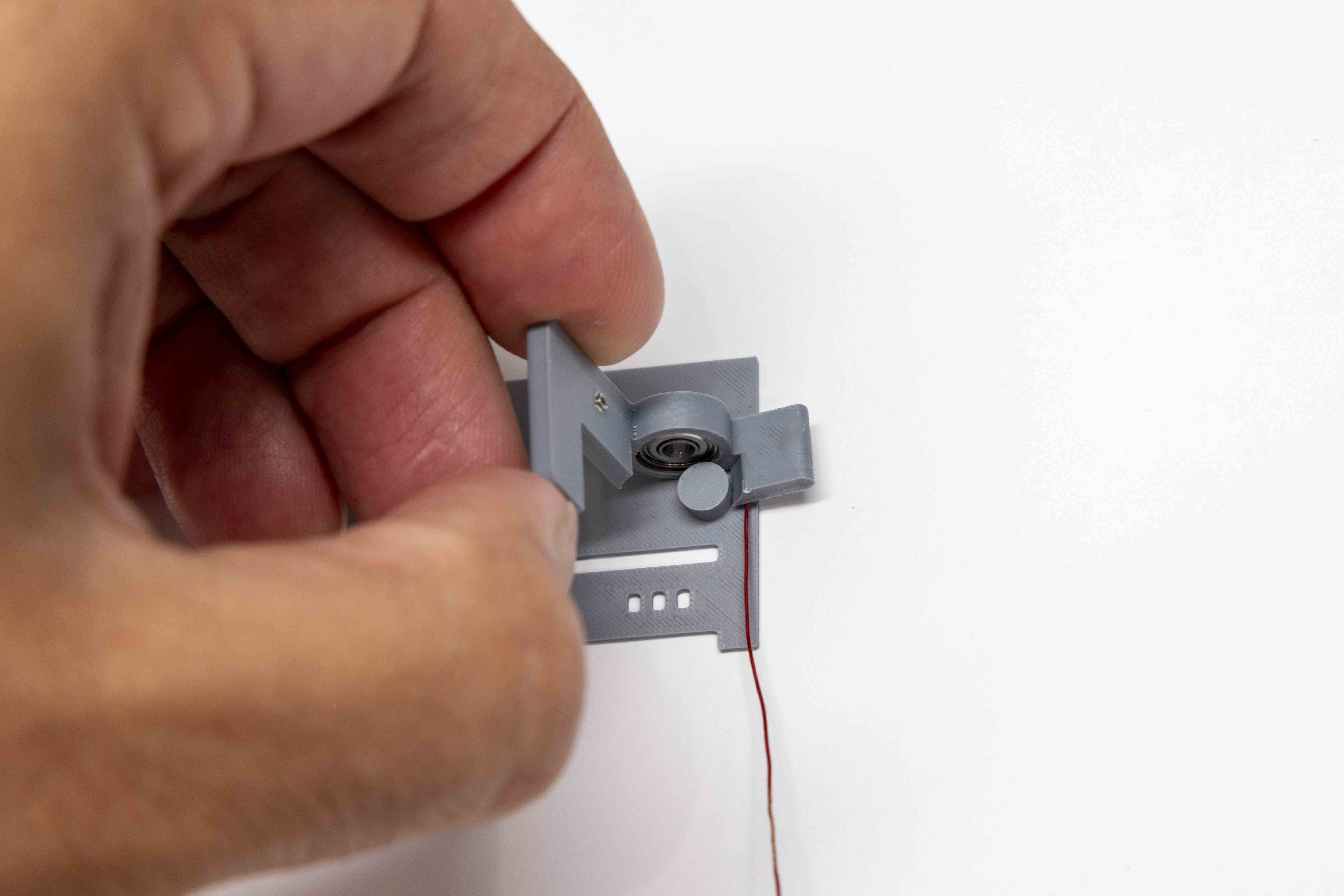 Left paddle positioned on radius guide for stress-relief loop winding