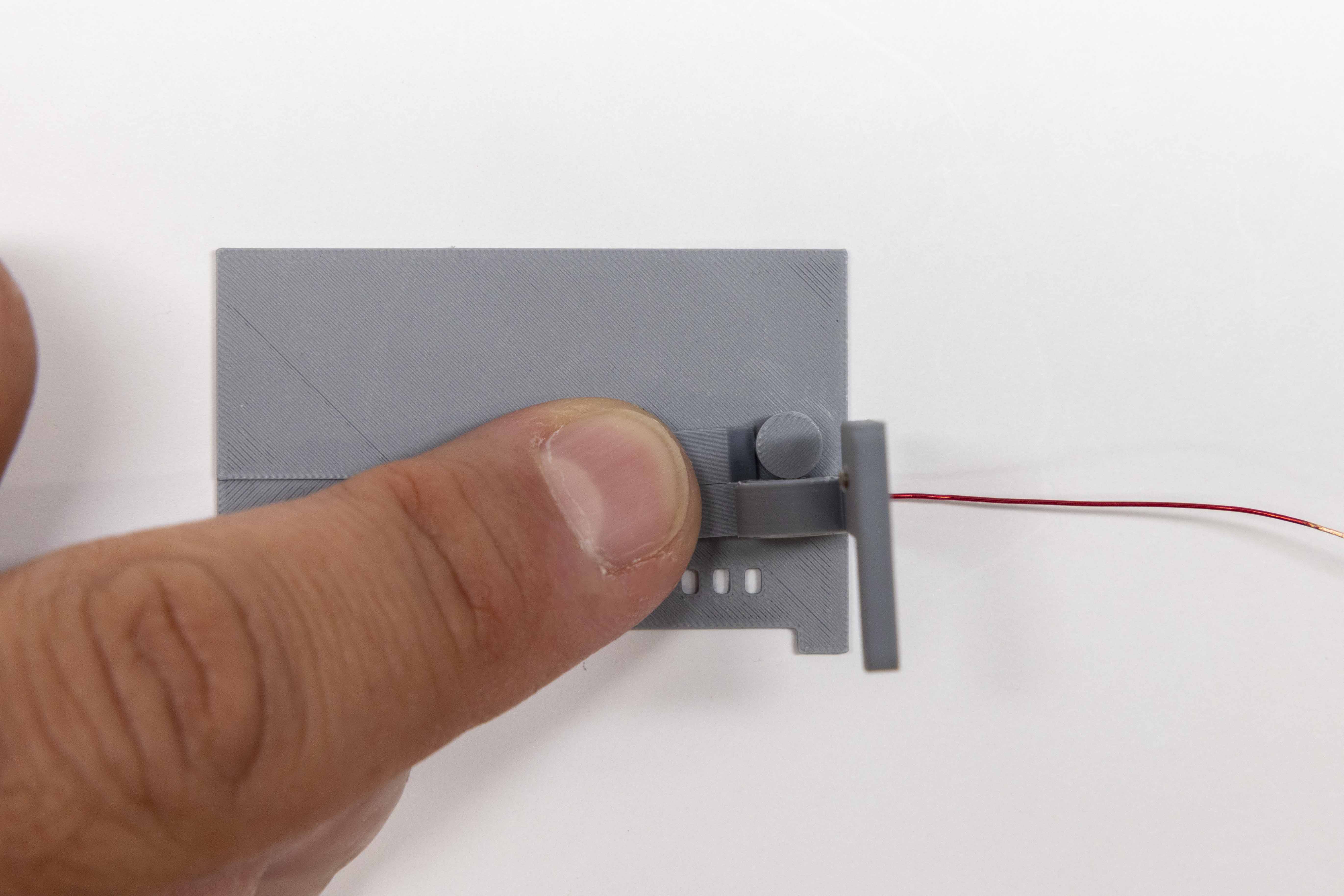 Right paddle positioned on radius guide for stress-relief loop winding